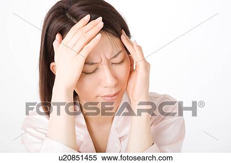 Stock Photography - A woman suffering from headache. Fotosearch