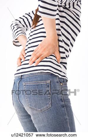 Stock Photo - A woman touching her back. Fotosearch