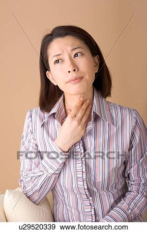 A woman touching throat View Large Photo Image Stock Photo - A woman touching throat. Fotosearch