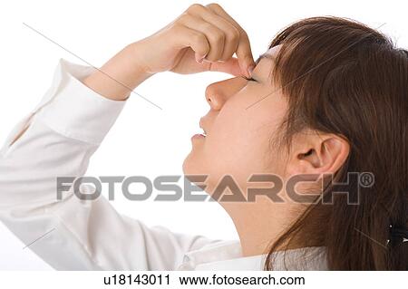 Stock Image - A young woman closing eyes. Fotosearch