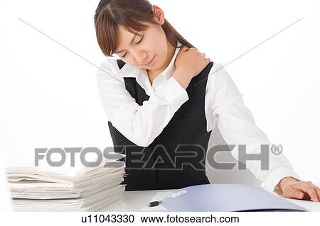 A young woman massaging shoulder View Large Photo Image Stock Image - A young woman massaging shoulder. Fotosearch
