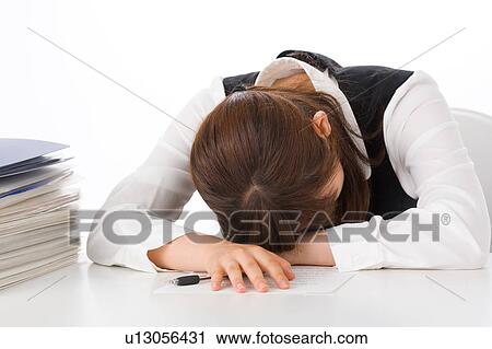 A young woman sleeping at her desk View Large Photo Image Stock Image - A young woman sleeping at her desk. Fotosearch