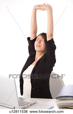 Stock Photo - A young woman stretching. Fotosearch