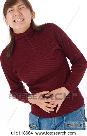 A young woman suffering from abdominal pain View Large Photo Image Picture - A young woman suffering from abdominal pain. Fotosearch