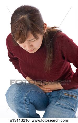A young woman suffering from abdominal pain View Large Photo Image Stock Photograph - A young woman suffering from abdominal pain. Fotosearch