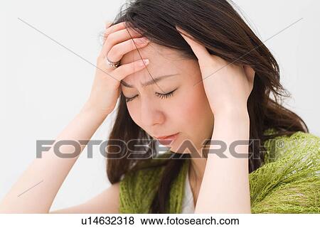 A young woman suffering from headache View Large Photo Image Stock Photo - A young woman suffering from headache. Fotosearch