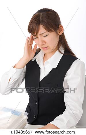 Stock Photo - A young woman suffering from headache. Fotosearch