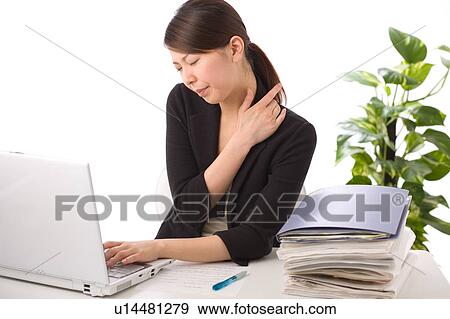 A young woman suffering from pain on shoulder View Large Photo Image Stock Photo - A young woman suffering from pain on shoulder. Fotosearch