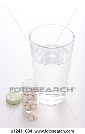 Picture - Medicine and glass of water. Fotosearch