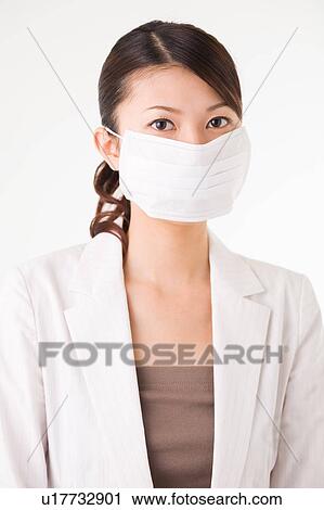 Young woman wearing mask View Large Photo Image Stock Image - Young woman wearing mask. Fotosearch