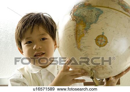 Boy holding globe View Large Photo Image Stock Photo - Boy holding globe. Fotosearch