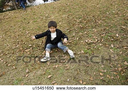 Boy playing in park View Large Photo Image Stock Image - Boy playing in park. Fotosearch