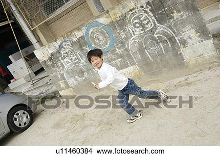 Picture - Boy playing in schoolyard. Fotosearch
