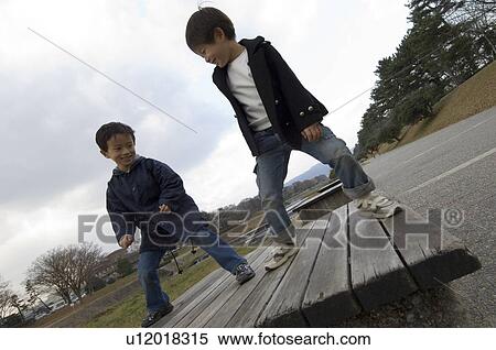 Boys playing in park View Large Photo Image Stock Photography - Boys playing in park. Fotosearch