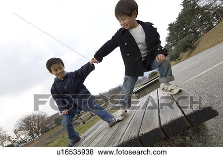 Boys pulling each other View Large Photo Image Stock Photo - Boys pulling each other. Fotosearch