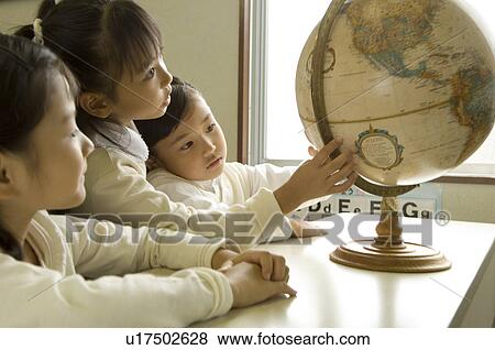 Children looking at globe View Large Photo Image Stock Photo - Children looking at globe. Fotosearch