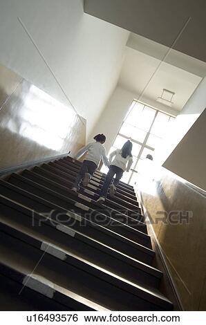 Stock Photograph - Children moving up staircase. Fotosearch