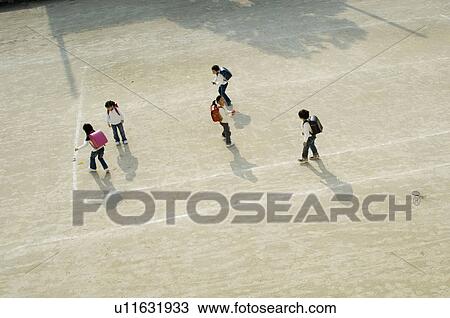 Stock Image - Children playing in schoolyard. Fotosearch