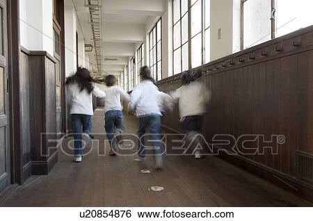 Stock Photograph - Children running in corridor, blurred motion. Fotosearch