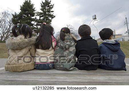 Stock Photography - Children sitting in a row. Fotosearch
