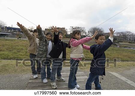 Stock Image - Children standing in a row. Fotosearch