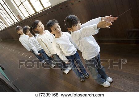 Stock Photo - Children standing in a row. Fotosearch