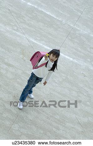 Girl standing in schoolyard View Large Photo Image Stock Image - Girl standing in schoolyard. Fotosearch