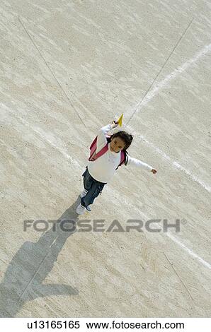 Girl throwing paper airplane View Large Photo Image Stock Photography - Girl throwing paper airplane. Fotosearch