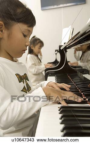 Girls playing piano View Large Photo Image Stock Image - Girls playing piano. Fotosearch