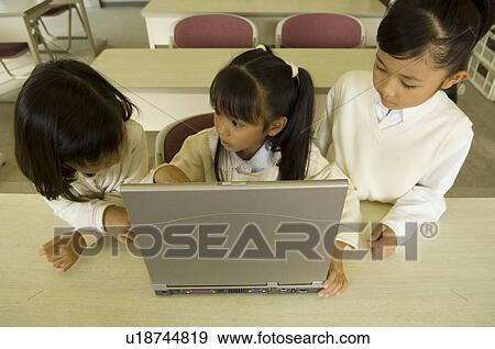 Stock Photo - Girls using computer. Fotosearch