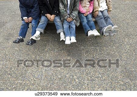 Stock Photo - Low section of children sitting. Fotosearch