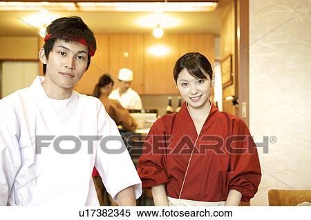 Stock Photography - Portrait of waiter and waitress at Japanese restaurant. Fotosearch