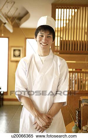Stock Photography - Portrait of young waiter at Japanese restaurant. Fotosearch
