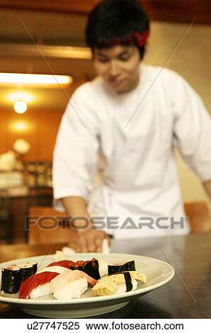 Stock Photography - Waiter cleaning table at Japanese restaurant. Fotosearch