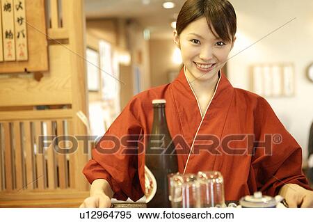 Stock Photography - Waitress carrying a tray of beer. Fotosearch