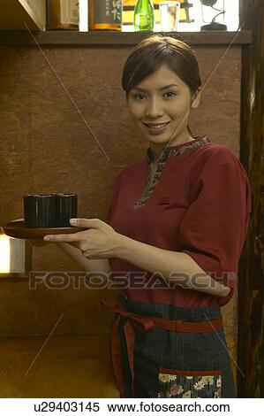 Waitress carrying a tray of tea View Large Photo Image Stock Photography - Waitress carrying a tray of tea. Fotosearch