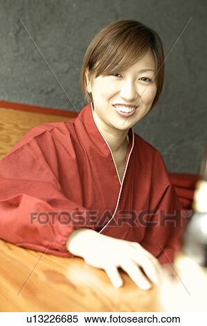 Stock Photography - Waitress sitting at table. Fotosearch