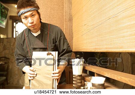 Young man cleaning table at restaurant View Large Photo Image Stock Image - Young man cleaning table at restaurant. Fotosearch