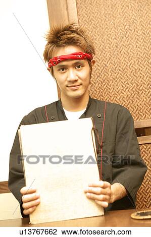 Young man holding menu View Large Photo Image Stock Image - Young man holding menu. Fotosearch