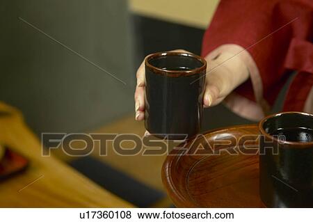 Young woman serving tea View Large Photo Image Stock Photo - Young woman serving tea. Fotosearch