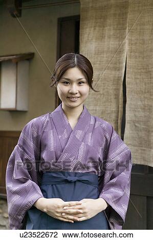 Young woman standing in front of restaurant View Large Photo Image Stock Image - Young woman standing in front of restaurant. Fotosearch