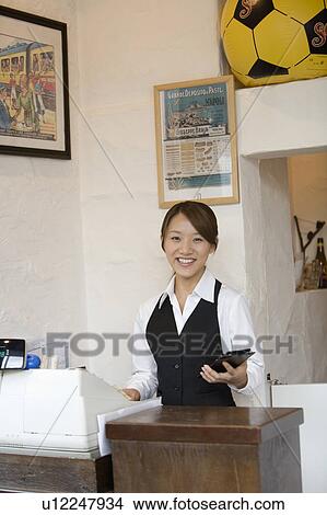 Picture - Cashier at checkout counter. Fotosearch