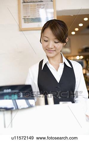 Stock Photo - Cashier at checkout counter. Fotosearch