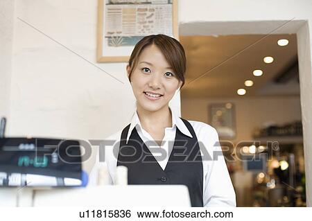 Stock Photograph - Cashier at checkout counter. Fotosearch