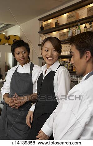 Chefs and waitress talking View Large Photo Image Stock Photo - Chefs and waitress talking. Fotosearch
