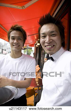 Two waiters standing in front of coffee shop View Large Photo Image Stock Photo - Two waiters standing in front of coffee shop. Fotosearch