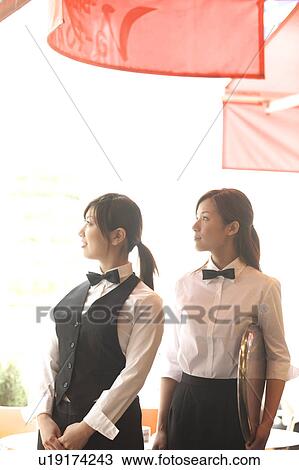 Stock Image - Two waitresses standing. Fotosearch