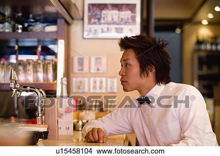Picture - Waiter at bar counter. Fotosearch