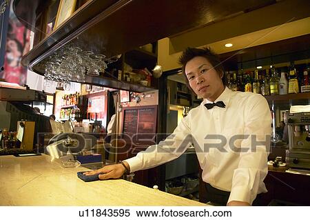Waiter cleaning bar counter View Large Photo Image Stock Photography - Waiter cleaning bar counter. Fotosearch