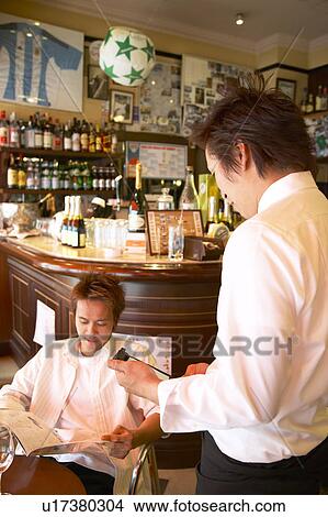 Picture - Waiter taking order. Fotosearch